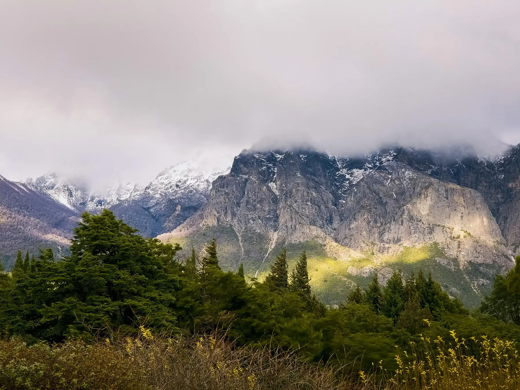 A sweeping Patagonian landscape under dramatic cloud formations.
