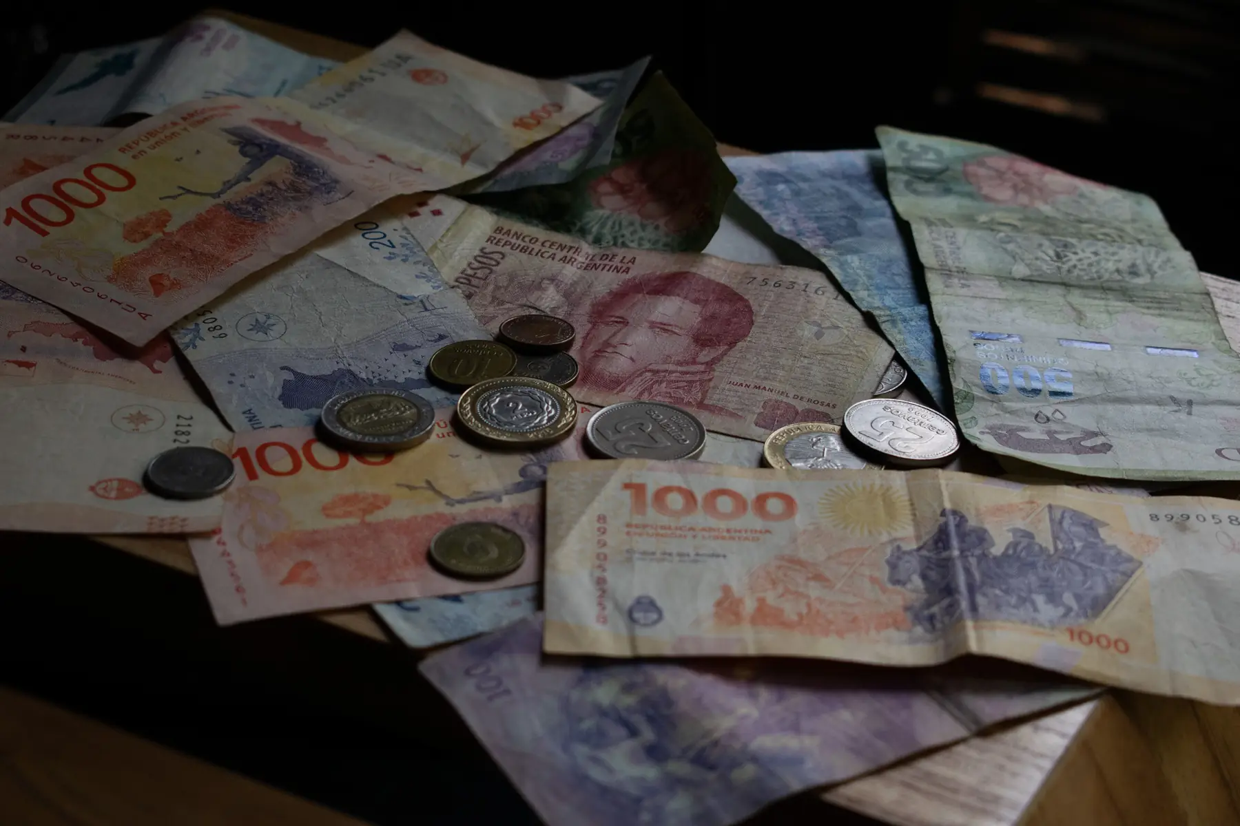 Chilean peso notes and a credit card beside a restaurant bill in Puerto Natales.