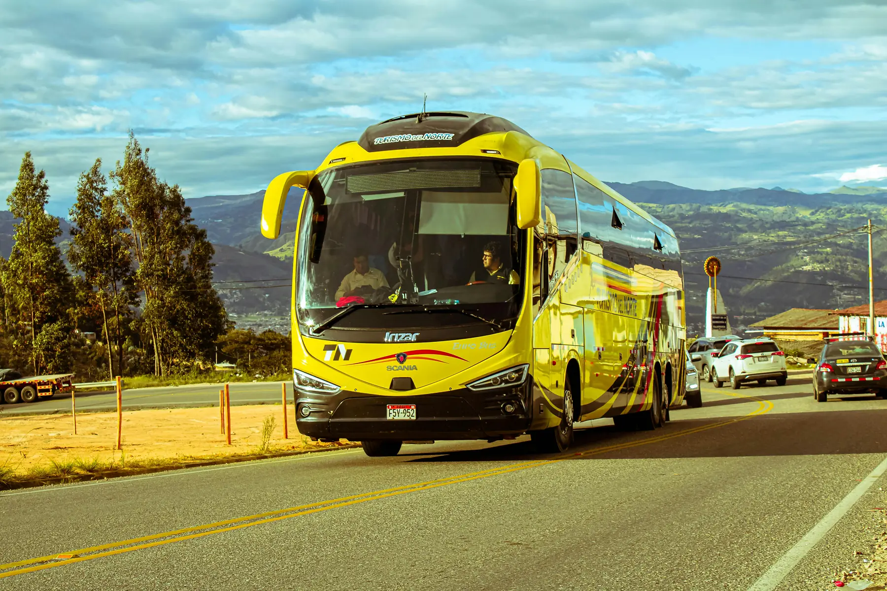 Passengers boarding a modern double-decker bus at a Patagonian bus terminal