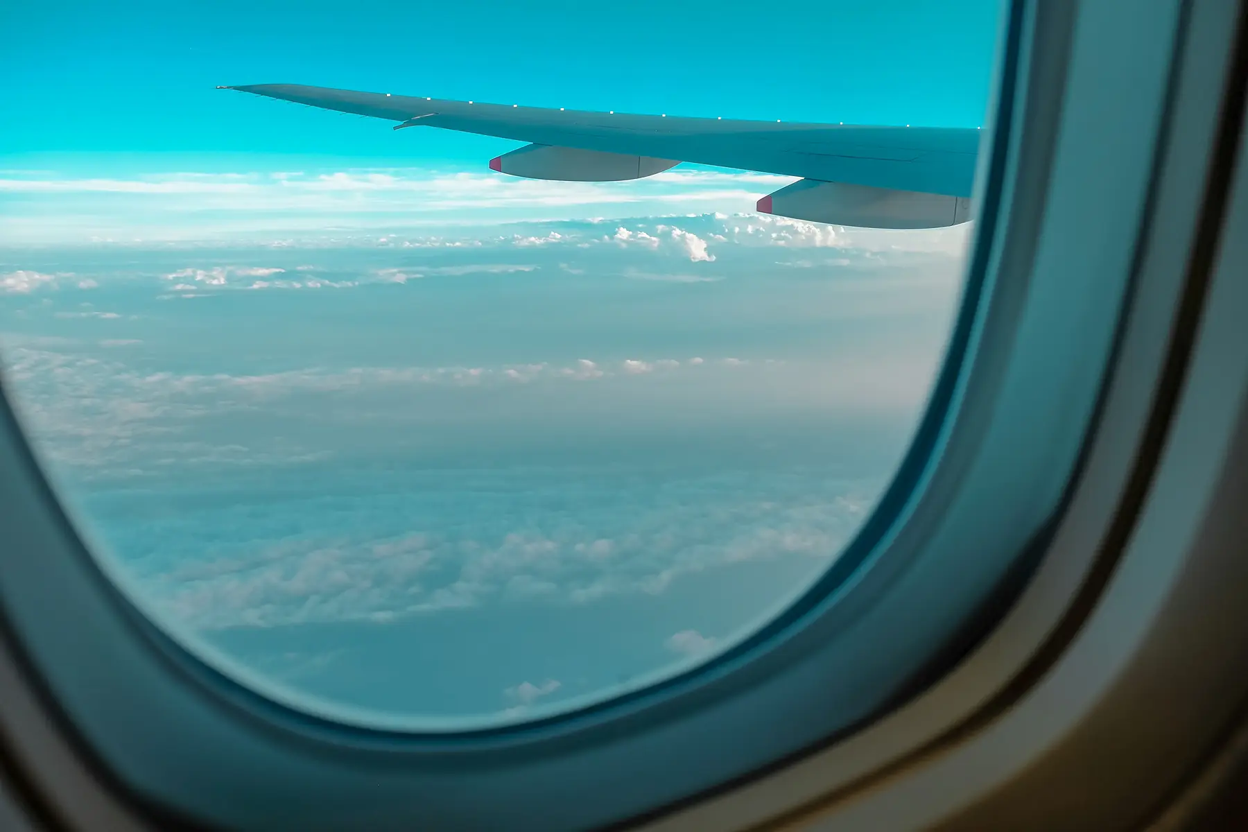 View through an aircraft window above the clouds en route to Patagonia