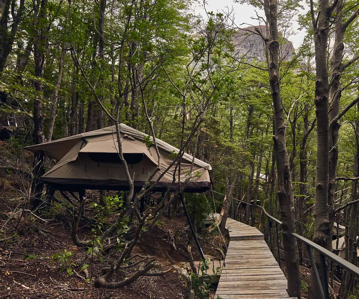 Hikers relaxing outside a W Trek lodge after a day on the trail.